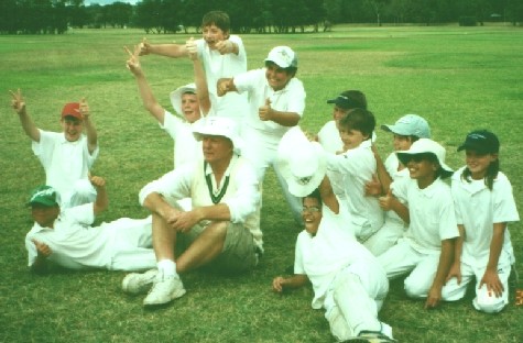 Our Premiership team with their medals 05-06U12Premiership Medal Team sitting 450pix